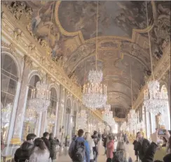  ?? Mary Winston Nicklin/For The Washington Post ?? Visitors take pictures as they walk through the Chateau de Versailles’s extravagan­t Hall of Mirrors in Versailles, France. At left, Temple de l'Amour on Marie Antoinette's Estate at Versailles.