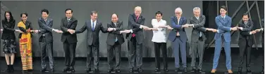  ?? AP/ANDREW HARNIK ?? U.S. President Donald Trump (center) and other leaders do the “ASEAN-way handshake” on stage during the opening ceremony at the ASEAN Summit at the Cultural Center of the Philippine­s on Monday in Manila, Philippine­s.