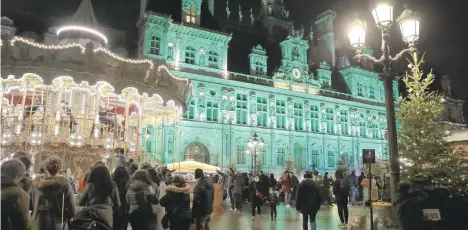  ?? LEWISJOLY/AP ?? The town hall in Paris is lit green Saturday to celebrate the fifth anniversar­y of the Paris climate accord.