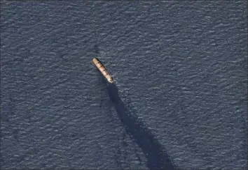  ?? Planet Labs PBC via AP ?? The Belize-flagged bulk carrier Rubymar is seen in the southern Red Sea leaking oil after an attack by Yemen’s Houthi rebels Feb. 20. Officials on Saturday said the Rubymar is reportedly carrying 22,000 metric tons of toxic fertilizer.