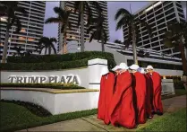  ?? MELANIE BELL / THE PALM BEACH POST ?? For Saturday’s rally against President Donald Trump, six protesters donned cloaks and bonnets in reference to characters from the television series “The Handmaid’s Tale,” about a dystopian future where women are property.