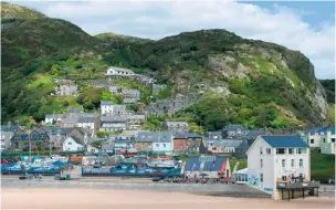  ??  ?? Barmouth sits at the foot of the Rhinogs and the sandy mouth of the Mawddach. Excellent for fish and chips. CHIPS AWAIT