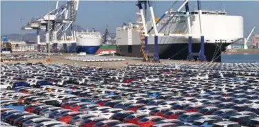  ?? Reuters ?? ↑
Cars to be exported sit at a terminal in the port of Yantai, Shandong province, China.