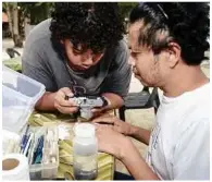  ??  ?? TOp: Researcher­s look at samples from their findings.
lEFT: Flora data collection in progress.