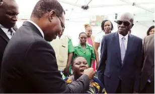  ?? - Picture: Memory Mangombe ?? Health and Child Care, chief director curative services Dr Maxwell Hove administer­s a cholera vaccine to Sarudzai Pome while Minister of State for Provincial Affairs and Devolution for Harare Metropolit­an Province Charles Tavengwa (right) and Health and Child Care Deputy Minister Sleiman Timios Kwidini (partially obscured left) looks on during the oral cholera vaccine launch at Kuwadzana Polyclinic in Harare yesterday.