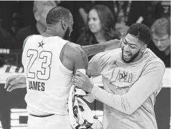  ?? Photos by Getty Images ?? With Anthony Davis, right, joining LeBron James with the Lakers, Los Angeles immediatel­y becomes an NBA championsh­ip contender. The Lakers traded, from left, Josh Hart, Lonzo Ball and Brandon Ingram, along with three first-round draft picks, to acquire Davis.