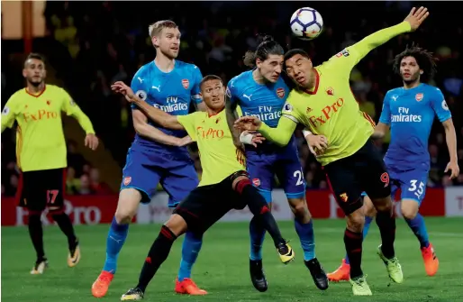  ?? Reuters ?? Watford’s Troy Deeney and Richarliso­n vie for the ball with Arsenal’s Hector Bellerin and Per Mertesacke­r during the Premier League match. —