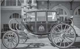  ?? Victoria Jones/Pool via AP ?? ■ The Scottish State Coach, which will be used in the case of wet weather for the wedding of Britain’s Prince Harry and Meghan Markle, is shown while it is prepared for the special day, in the Royal Mews on Tuesday at Buckingham Palace in London.