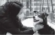  ?? KIM HONG-JI Reuters ?? Moon Sae-mi and her dog Godot demonstrat­e Petpuls, an AI-powered smart dog collar, in Seoul, South Korea.