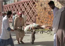  ?? PHOTO: REUTERS ?? Victim: Afghan men carry an injured man to a hospital after the suicide attack in Nangarhar province.