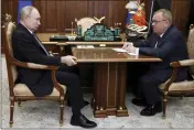  ?? ALEXANDER KAZAKOV, SPUTNIK, KREMLIN POOL PHOTO VIA AP ?? Russian President Vladimir Putin, left, listens to VTB Bank Chairman Andrei Kostin during their meeting in Moscow on July 11.