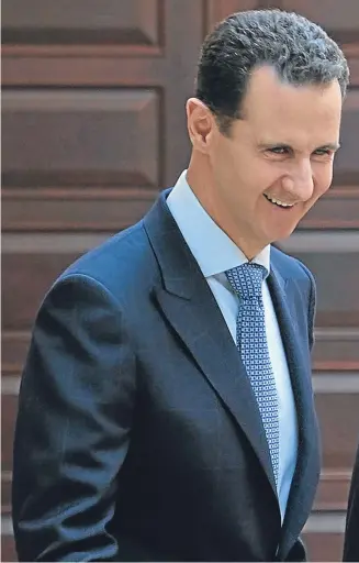  ??  ?? CALM BEFORE THE STORM?: President Assad, left, chats with Ali Akbar Velayati, an adviser to Iran’s Supreme Leader Ayatollah Ali Khamenei, in Damascus yesterday