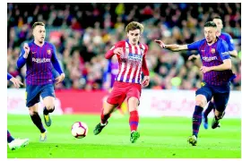  ?? AP ?? In this April 2019 file photo, Atlético forward Antoine Griezmann (centre) vies for the ball with Barcelona midfielder Arthur (left) and Barcelona defender Clement Lenglet during a Spanish La Liga match in Barcelona, Spain.