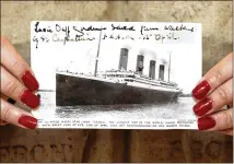  ?? MICHAEL CRABTREE / BLOOMBERG ?? A postcard of the Titanic is displayed at Christie’s in London in 2007. Premier Exhibition­s holds the rights to the ship and 5,500 Titanic artifacts.