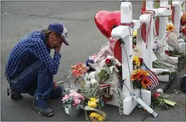  ?? JOHN LOCHER — THE ASSOCIATED PRESS ?? Antonio Basco cries beside a makeshift memorial near the scene of a mass shooting in El Paso, Texas. Basco’s wife, Margie Reckard, was among 22killed in the Aug. 3attack.