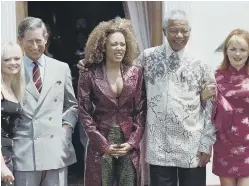  ?? ?? Prince Charles of Wales and South African President Nelson Mandela pose flanked by Spice Girl Emma (L), Mel B (middle) and Geri (R) at the Presidenti­al residence at Pretoria on November 1, 1997. Photo by Odd ANDERSEN / AFP via Getty Images