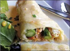  ?? Arkansas Democrat-Gazette/JENNIFER NIXON ?? The crepe of the day, covered in lobster sauce and stuffed with crab meat, shrimp, salmon, asparagus and cheese, comes with fruit and a side salad or soup at Brave New Restaurant.