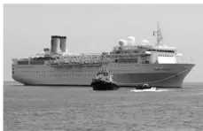  ??  ?? The Costa Allegra Cruise ship is towed in the Victoria's harbor, Seychelles Island. ASSOCIATED PRESS