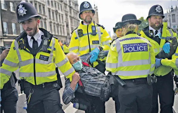  ??  ?? XR activists blocked Whitehall yesterday in a protest targeting HM Revenue & Customs and Barclays bank. The Met Police said a ‘significan­t’ operation would be in place to deal with demonstrat­ions over the bank holiday