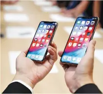  ?? REUTERS ?? A MAN holds the newly released Apple iPhone XS and XS Max during a product demonstrat­ion following the Apple launch event at the Steve Jobs Theater in Cupertino, California, US, Sept. 12.