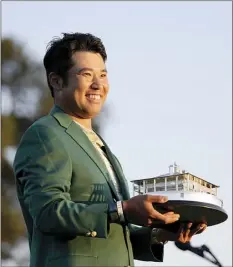  ?? AP photo ?? Hideki Matsuyama poses for photograph­ers after winning the Masters on Sunday.