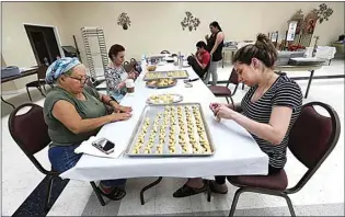  ?? ALEX HORVATH / THE CALIFORNIA­N ?? Mary Mekhel and Evanthia Frazier help prepare koulouraki­a, a cookie that the ladies at the St. George Greek Orthodox Church hope to make more than 700 of for the Bakersfiel­d Greek Food Festival, which will be held as a takeout event over four weekends in October.