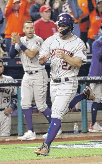  ?? ROB CARR/GETTY IMAGES ?? Astros second baseman Jose Altuve doubled twice and scored twice Friday in Game 3.