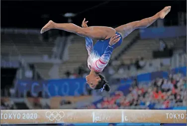 ?? Associated Press ?? Bronze for Biles: Simone Biles, of the United States, performs on the balance beam during the artistic gymnastics WOMEN'S APPARATUS fiNAL AT THE 2020 SUMMER OLYMPICS TUESDAY IN TOKYO, JAPAN.