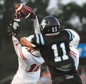  ?? Barry Reeger/For the Post-Gazette ?? Moon’s Taite Beachy intercepts a pass intended for Seneca Valley’s Luke Lawson.