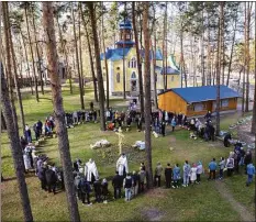  ?? John Moore / Getty Images ?? As seen from an aerial view, priests perform blessings while celebratin­g Orthodox Easter outside a war-damaged church in Kyiv, Ukraine, on April 24.