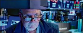  ?? Richard Drew / Associated Press ?? Trader Michael Conlon works on the floor of the New York Stock Exchange on Friday. Stocks edged lower Friday.