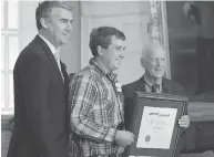  ??  ?? Premier Stephen McNeil, left, and advisory board chair Hugh Laurence, flank Travis Wolfe, a Nova Scotia Medal of Bravery recipient, at Province House in Halifax. ANDREW VAUGHAN / THE CANADIAN PRESS