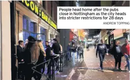  ?? ANDREW TOPPING ?? People head home after the pubs close in Nottingham as the city heads into stricter restrictio­ns for 28 days