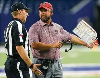  ?? Brett Coomer / Houston Chronicle ?? Westfield football coach Matt Meekins argues a call during a Class 6A game last fall. A dispute with a coach is one of the least-attractive aspects of officiatin­g a high school game.