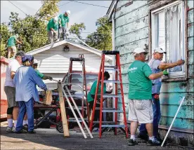  ?? CHRIS STEWART / STAFF ?? Volunteers from Shiloh Church work to help repair Jessica Brady’s house in Harrison Twp. Many groups preparing to help the region recover from last year’s tornadoes are waiting for the virus pandemic to be over.