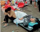  ?? AP ?? Earthquake survivors are treated outside a hospital in Cianjur after an earthquake that killed at least 162 people.