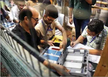  ?? PIC/NAVEEN SHARMA ?? Polling officials at a counting centre, in New Delhi, on Tuesday