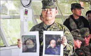  ?? FERDINANDH CABRERA/AFP ?? Philippine military chief General Eduardo Ano shows images of Islamic militant leaders Isnilon Hapilon (right) and Omarkhayam Maute (left) in Marawi yesterday.