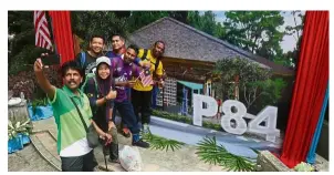  ??  ?? Up and running soon: A group of hikers posing with the graphic impression of the refurbishe­d Station 84 during the Station 84 Refurbishm­ent Project ground-breaking ceremony at Penang Hill.