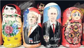  ?? AP ?? In this Monday, February 20, 2017, photo, traditiona­l Russian nesting dolls depicting US President Donald Trump (second left) and Russian President Vladimir Putin are displayed for sale at a souvenir street shop in St Petersburg, Russia.