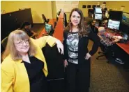  ?? AP PHOTO/CHUCK BURTON ?? Amanda Crawford, right, and Nancy Rainosek stand photo inside the state’s Informatio­n Resources Command Center in Austin, Texas, earlier this month.