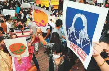  ?? AFP ?? ■ Women’s rights activists hold placards during a demonstrat­ion in Lahore on July 24, 2021, against the brutal killing of Noor Mukadam.