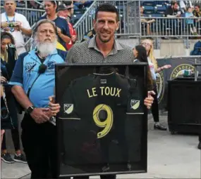  ?? MIKEY REEVES — FOR DIGITAL FIRST MEDIA ?? Sebastien Le Toux holds a framed No. 9 jersey after he was inducted to the Union’s Ring of Honor at halftime of Saturday’s game against Vancouver at Talen Energy Stadium.