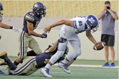  ??  ?? St. Michael’s quarterbac­k Lucas Coriz, right, gets tackled by Santa Fe High’s Cameron Romero during the first quarter of Friday’s game.