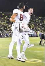  ?? Steve Dykes / Getty Images ?? Parkinson (left), a tight end, elevates with quarterbac­k K.J. Costello after their TD.