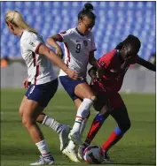  ?? ?? The United States' Mallory Pugh, center, and Sherly Jeudy of Haiti battle for the ball during Monday's CONCACAF W Championsh­ip opening match in Monterrey, Mexico.