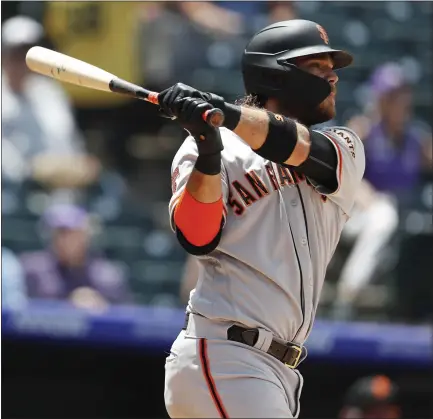  ?? DAVID ZALUBOWSKI — THE ASSOCIATED PRESS ?? The Giants’ Brandon Crawford follows the flight of his two-run home run in Game 1. Crawford had a big day, hitting three homers and driving in nine.