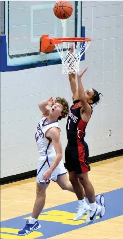  ?? PILOT PHOTO/RON HARAMIA ?? Triton’s John Gardner scores two of his 14 points on this fast break layup during high school boys basketball action Monday night.