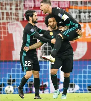  ?? Photo: AFP ?? Real Madrid’s Brazilian defender Marcelo (C) celebrates scoring with his teammates during the UEFA Champions League semi-final first-leg football match yesterday