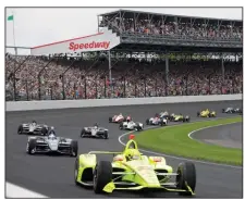  ?? (AP/Darron Cummings) ?? Simon Pagenaud leads the field through the first turn on the start of the 2019 Indianapol­is 500. May is normally a busy month at the Indianapol­is Motor Speedway, but not this year as the IndyCar season has been put on hold because of the coronaviru­s pandemic.